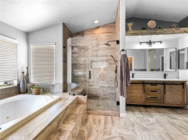 a spacious bedroom with a bed and a flat screen tv