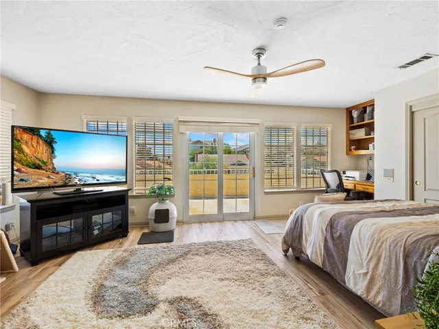 a view of a balcony with floor to ceiling windows with wooden floor