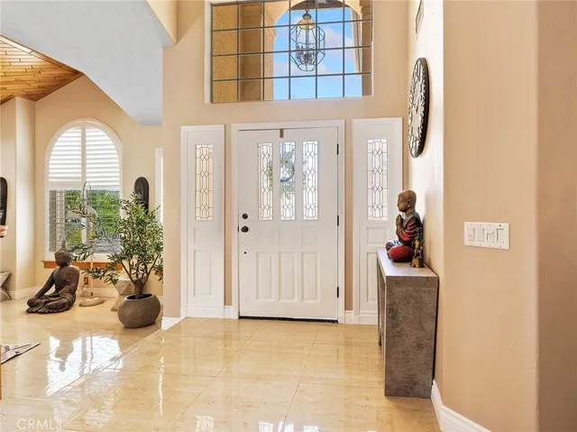 a view of staircase with lots of frames on wall and a potted plant