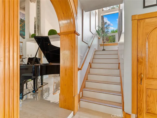 a balcony with wooden floor table and chairs