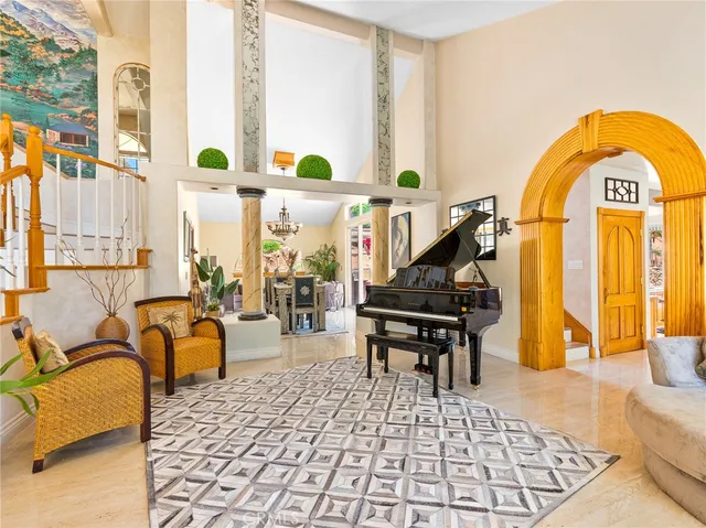 a living room with furniture and a potted plant