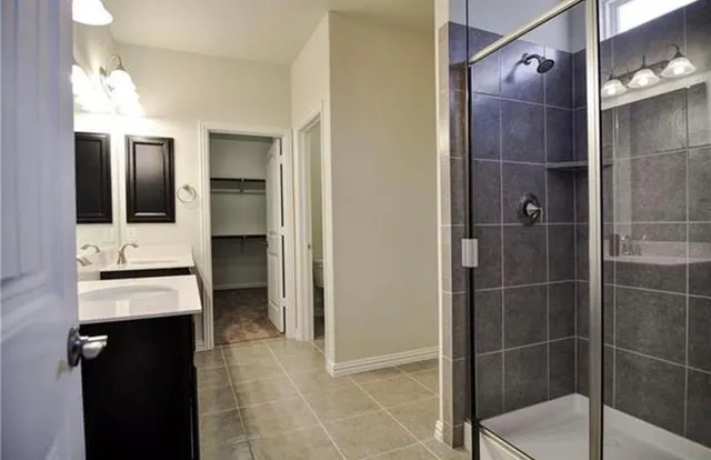 a bathroom with a shower and a sink