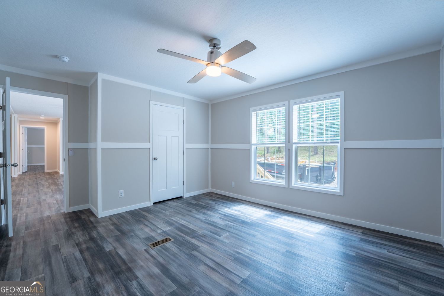 734 Hollywood Church Road Clarkesville, GA 30523 - Photo 25 of 49 an empty room with wooden floor and windows