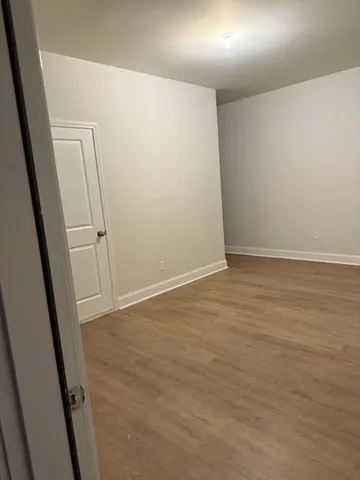 an empty room with wooden door