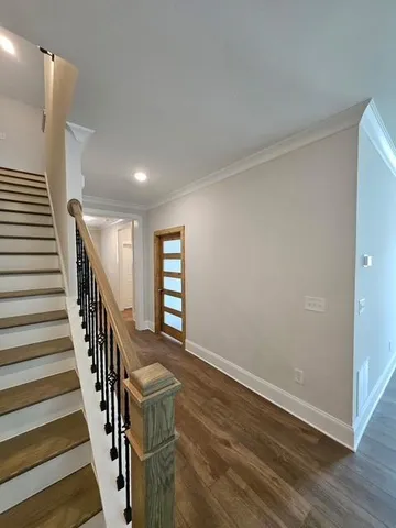 a view of entryway with wooden floor and stairs