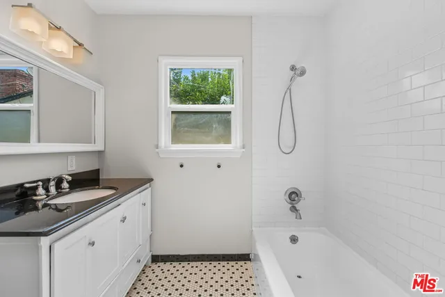 a kitchen with a refrigerator a sink and dishwasher with wooden floor