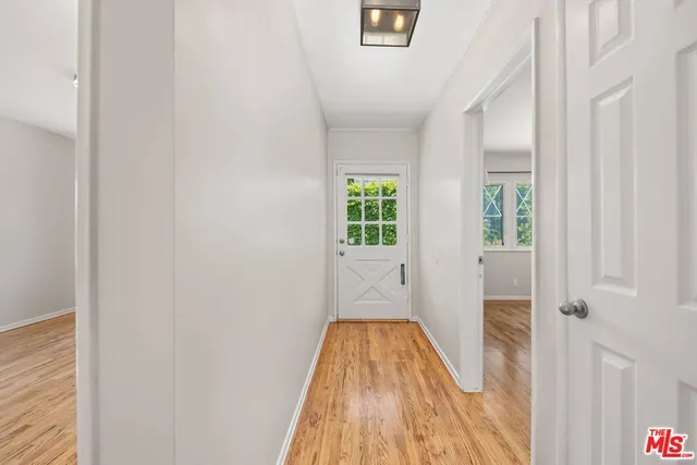 a view of empty room with wooden floor and fireplace