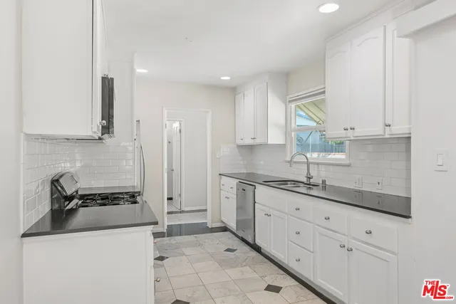 a view of walk in closet with empty room
