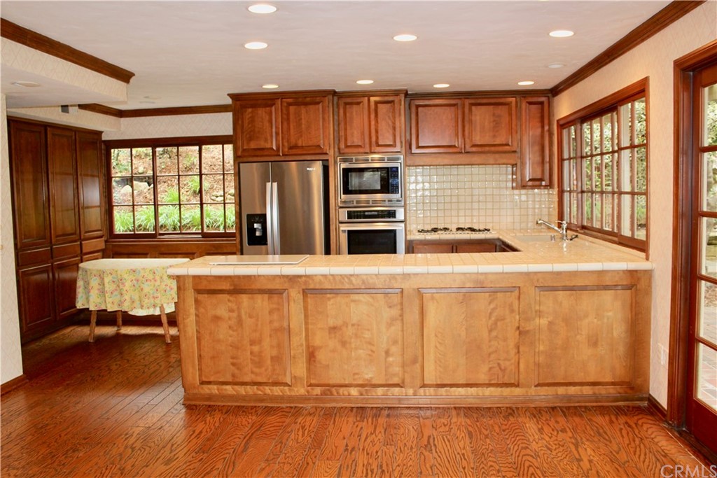 6832 Verde Ridge Road Rancho Palos Verdes, CA 90275 - Photo 11 of 26 a kitchen with kitchen island granite countertop wooden cabinets and a sink
