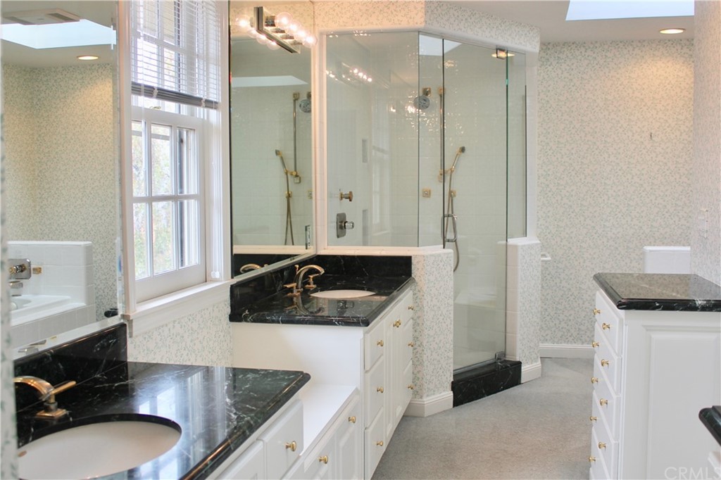 6832 Verde Ridge Road Rancho Palos Verdes, CA 90275 - Photo 19 of 26 a bathroom with a granite countertop sink a mirror and a shower