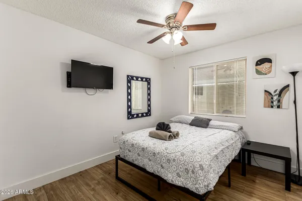 a bedroom with a bed and a flat screen tv