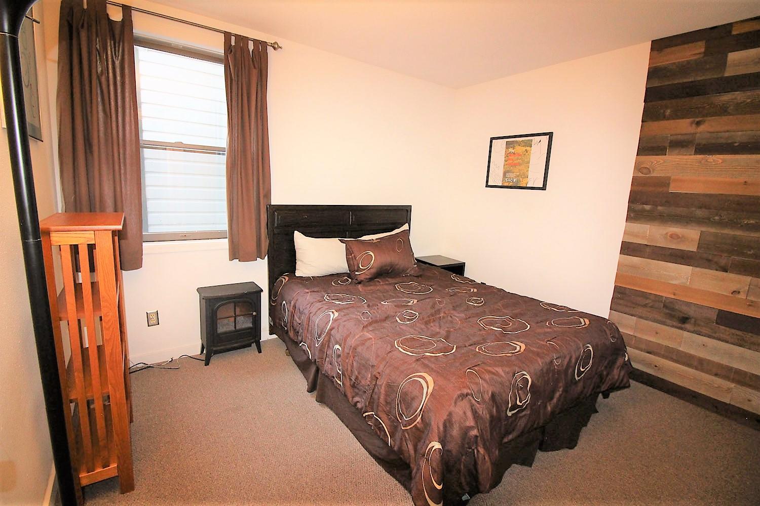 129 West San Juan Avenue, Unit R11 Telluride, CO 81435 - Photo 7 of 18 a bedroom with a bed next to a window