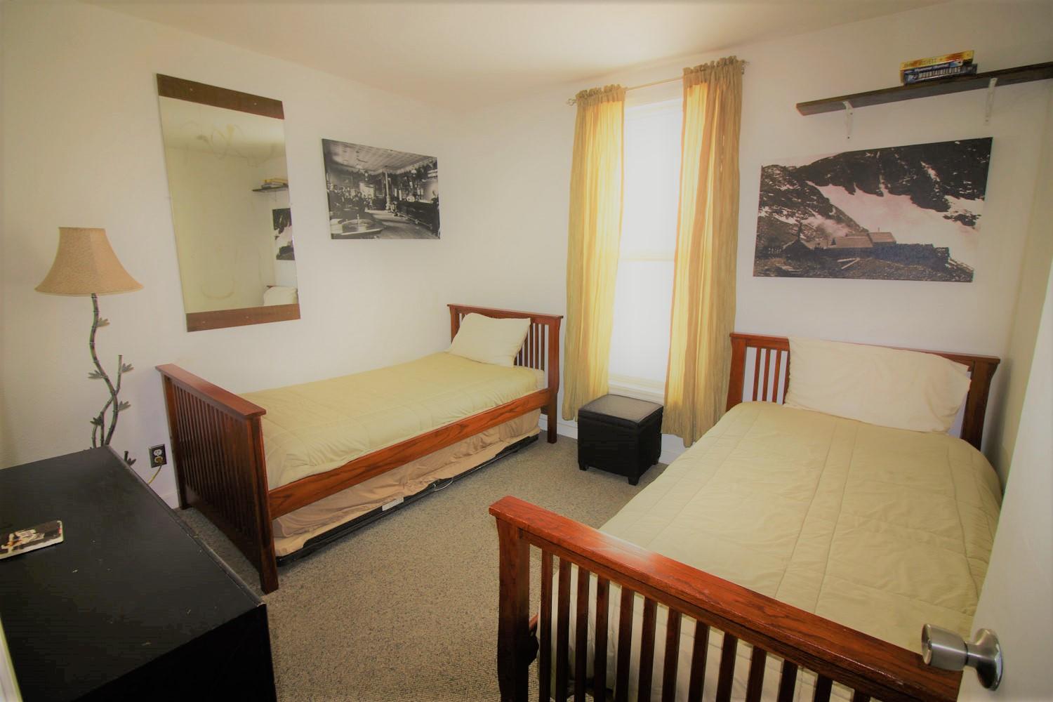 129 West San Juan Avenue, Unit R11 Telluride, CO 81435 - Photo 8 of 18 a bedroom with a bed and wall painting
