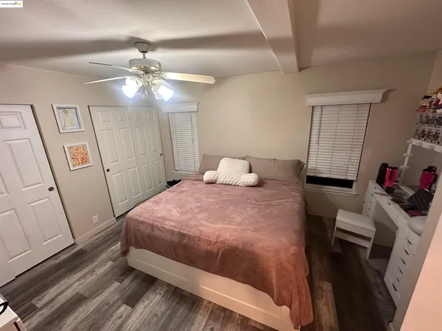 a bedroom with a bed and a mirror