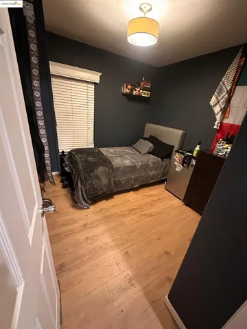 a bedroom with a bed dresser and a window