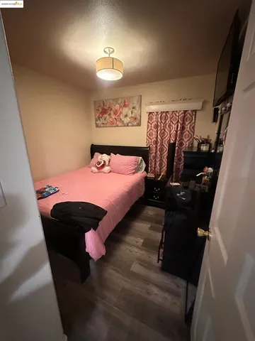 a bedroom with a bed and window