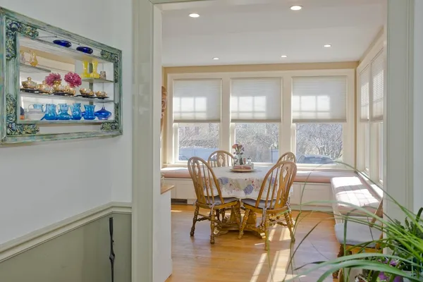 a view of a dining room with furniture a chandelier and wooden floor