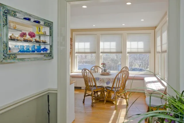 a view of a dining room with furniture a chandelier and wooden floor