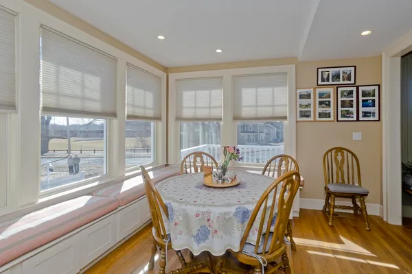 a dining room with furniture mountain view and wooden floor