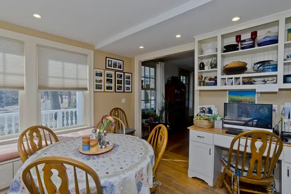 a dining room with furniture and wooden floor
