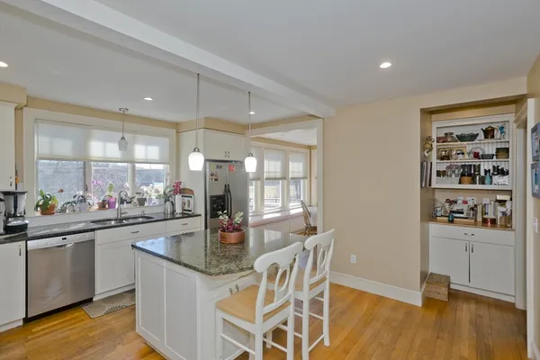 a kitchen with granite countertop a sink and cabinets