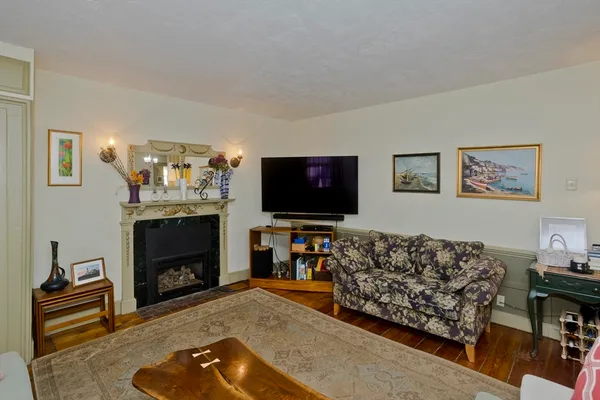 a living room with furniture a flat screen tv and a fireplace