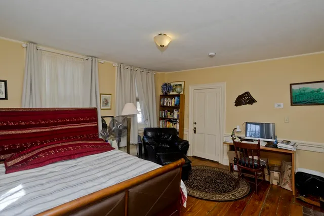 a bed room with a bed and a television