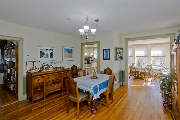 a living room with dining room and wooden floor