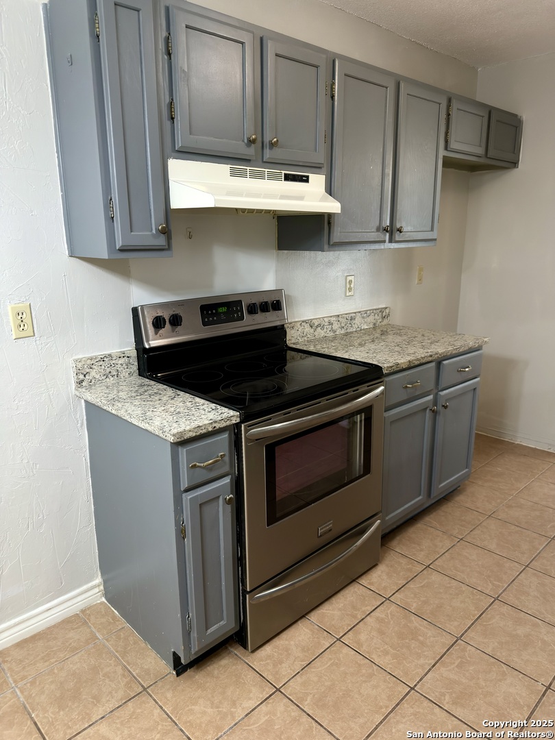7334 Mystery Ridge Drive Converse, TX 78109 - Photo 11 of 26 a kitchen with stainless steel appliances granite countertop a stove a sink and a refrigerator