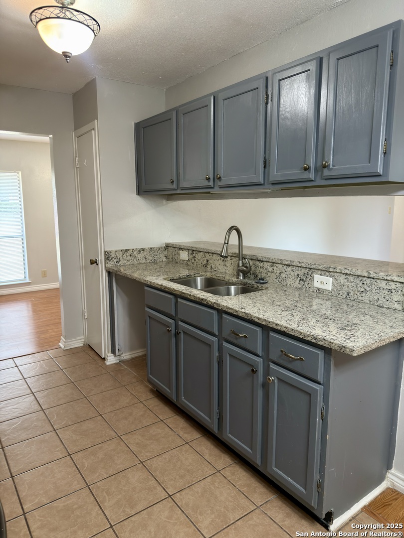 7334 Mystery Ridge Drive Converse, TX 78109 - Photo 12 of 26 a kitchen with stainless steel appliances granite countertop a sink and a stove