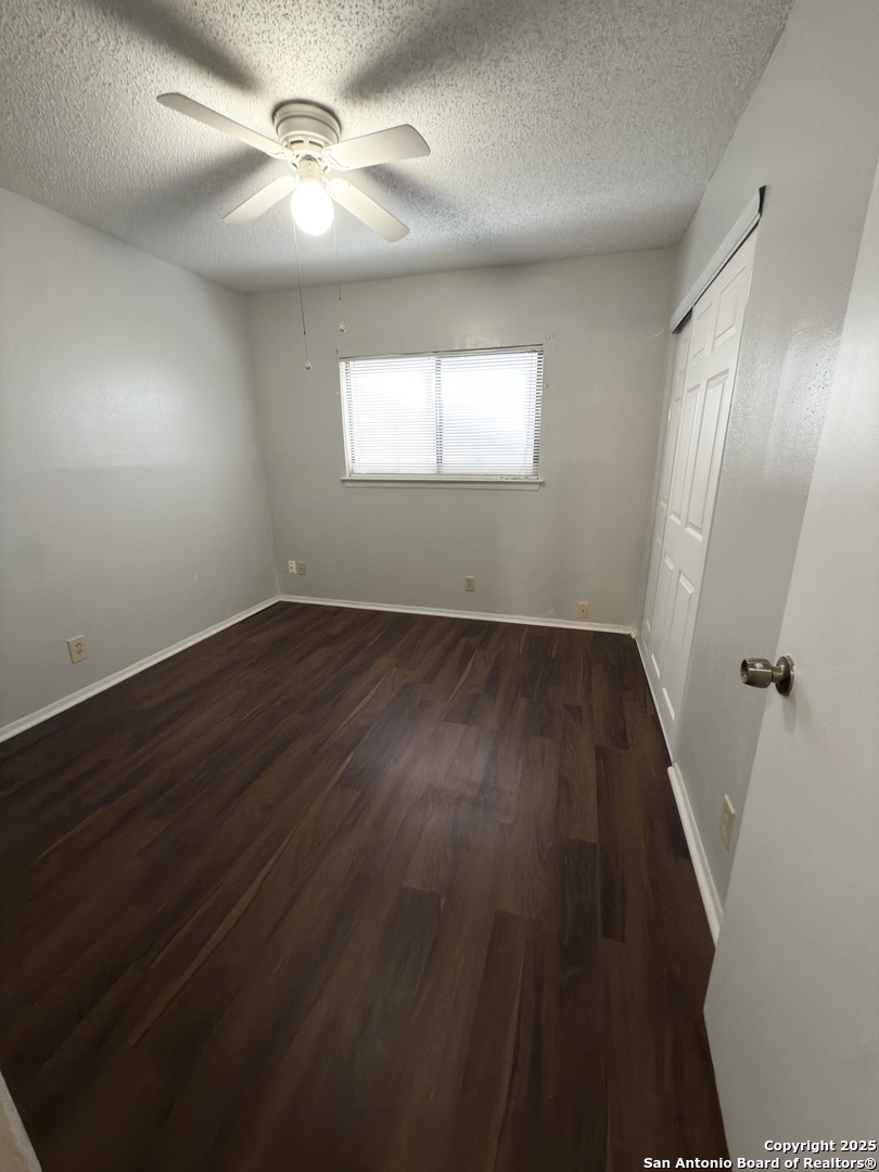 7334 Mystery Ridge Drive Converse, TX 78109 - Photo 13 of 26 an empty room with wooden floor fan and windows