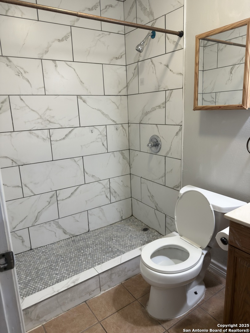 7334 Mystery Ridge Drive Converse, TX 78109 - Photo 15 of 26 a bathroom with a toilet and a shower