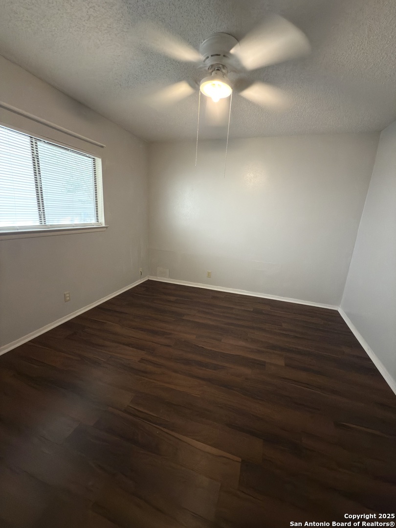 7334 Mystery Ridge Drive Converse, TX 78109 - Photo 16 of 26 a view of an empty room with wooden floor and a window