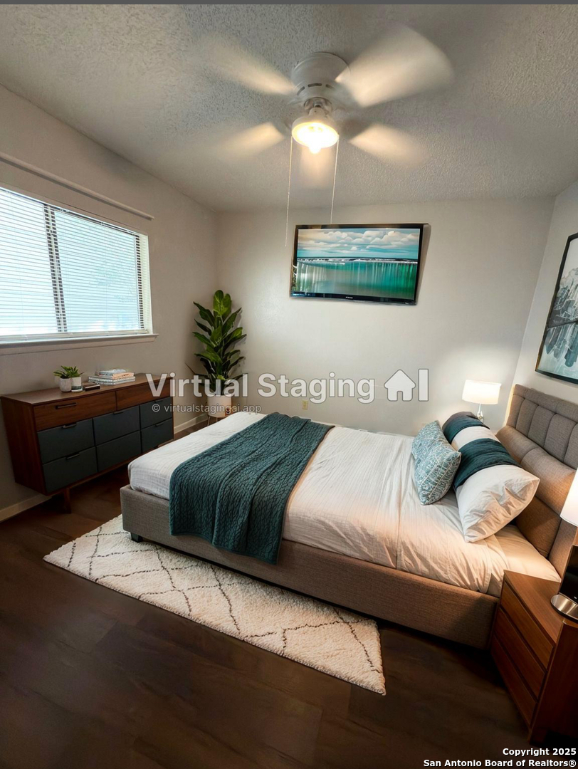 7334 Mystery Ridge Drive Converse, TX 78109 - Photo 17 of 26 a bedroom with a bed and a chandelier