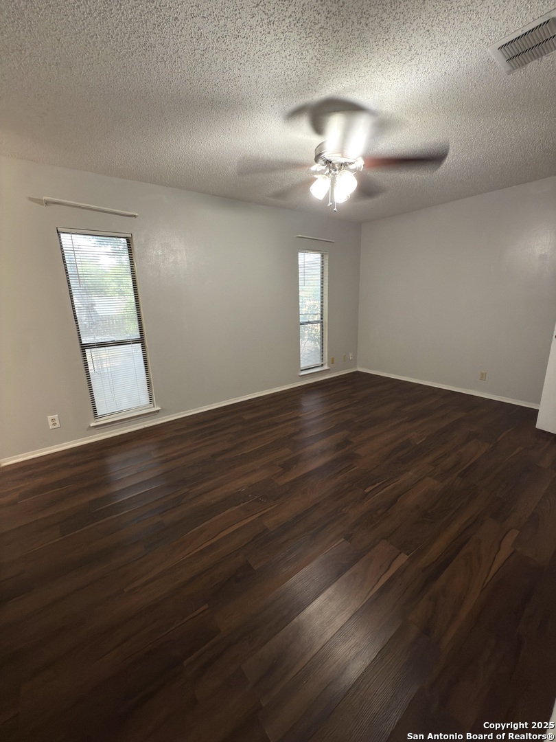 7334 Mystery Ridge Drive Converse, TX 78109 - Photo 18 of 26 a view of an empty room with wooden floor and a window