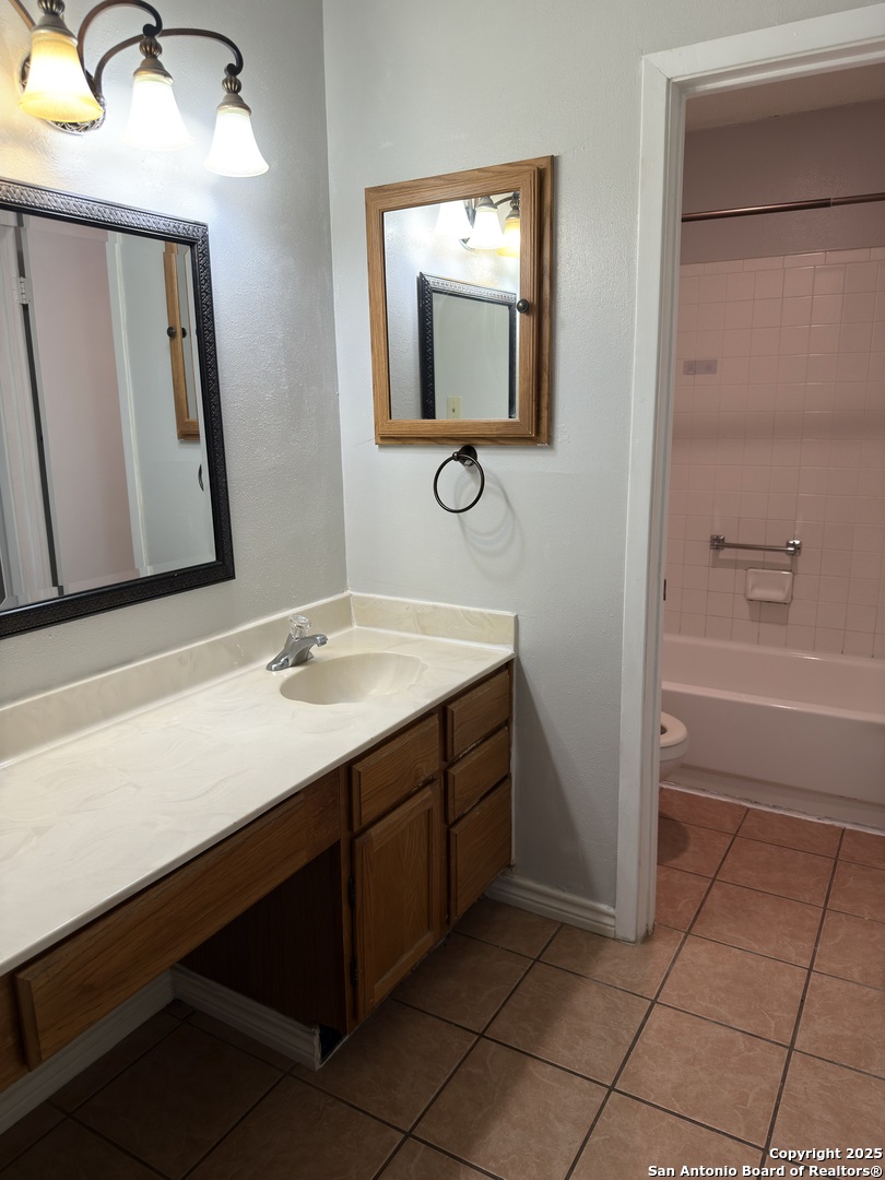 7334 Mystery Ridge Drive Converse, TX 78109 - Photo 21 of 26 a bathroom with a sink a toilet and mirror