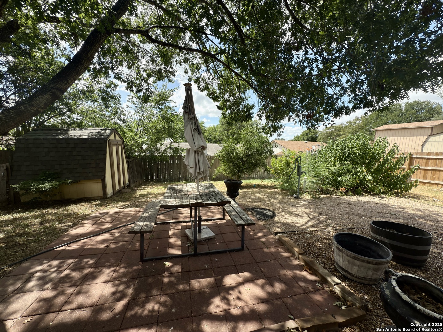 7334 Mystery Ridge Drive Converse, TX 78109 - Photo 24 of 26 a view of a backyard with table and chairs and a fire pit
