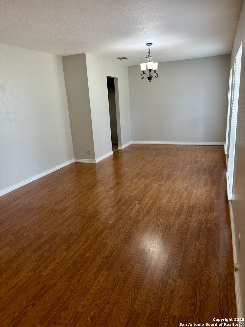 7334 Mystery Ridge Drive Converse, TX 78109 - Photo 4 of 26 wooden floor in an empty room with a window