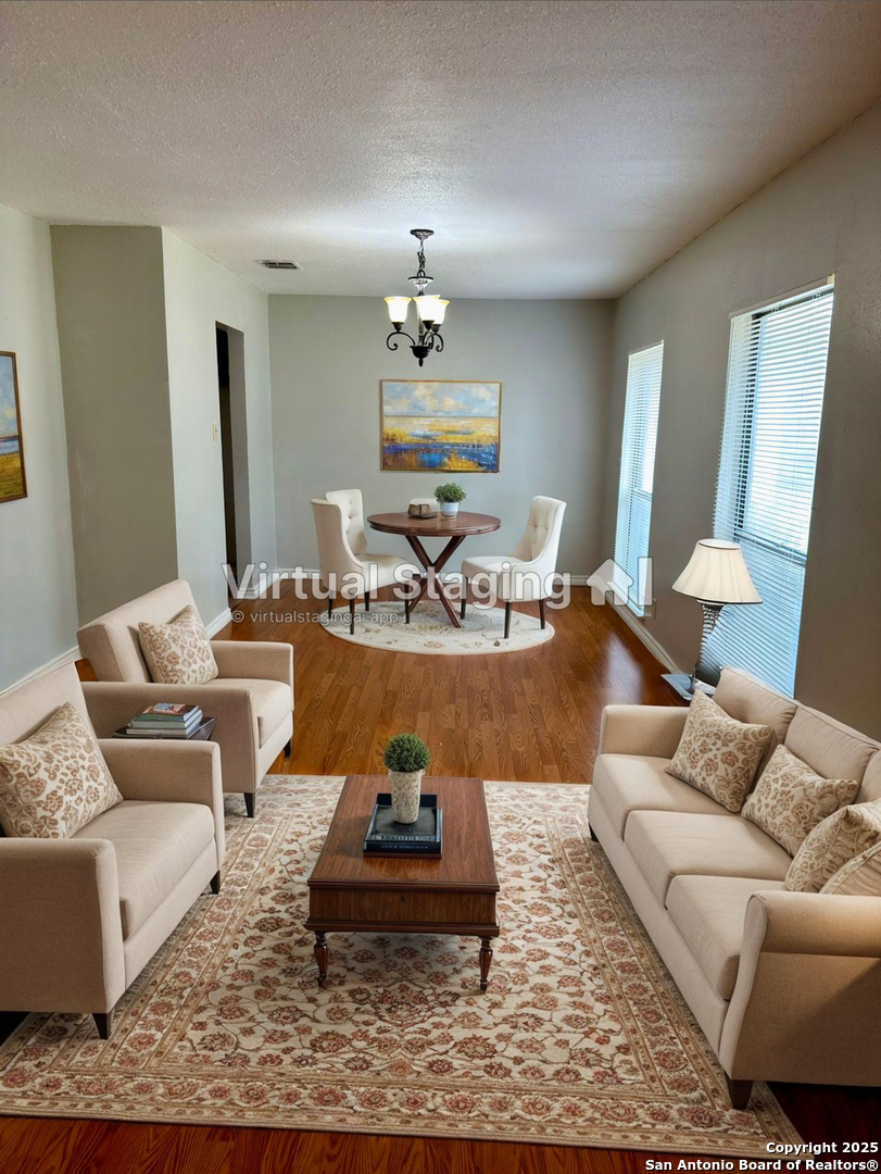 7334 Mystery Ridge Drive Converse, TX 78109 - Photo 5 of 26 a living room with furniture and a chandelier