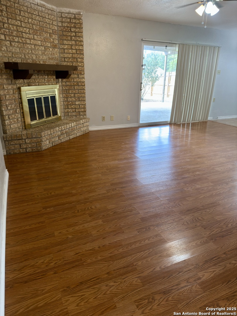 7334 Mystery Ridge Drive Converse, TX 78109 - Photo 6 of 26 an empty room with wooden floor and windows