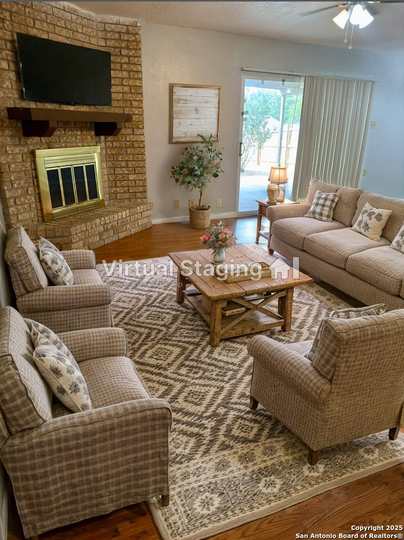 7334 Mystery Ridge Drive Converse, TX 78109 - Photo 7 of 26 a living room with fireplace furniture and a flat screen tv