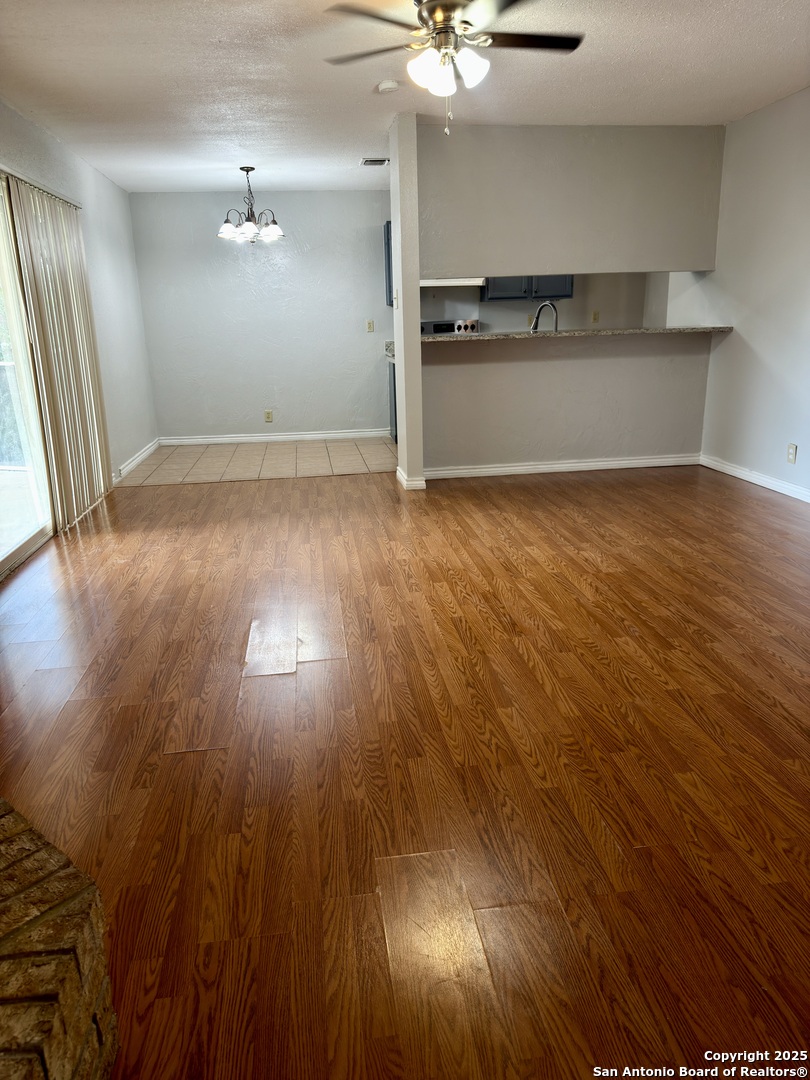 7334 Mystery Ridge Drive Converse, TX 78109 - Photo 8 of 26 wooden floor in an empty room with a window