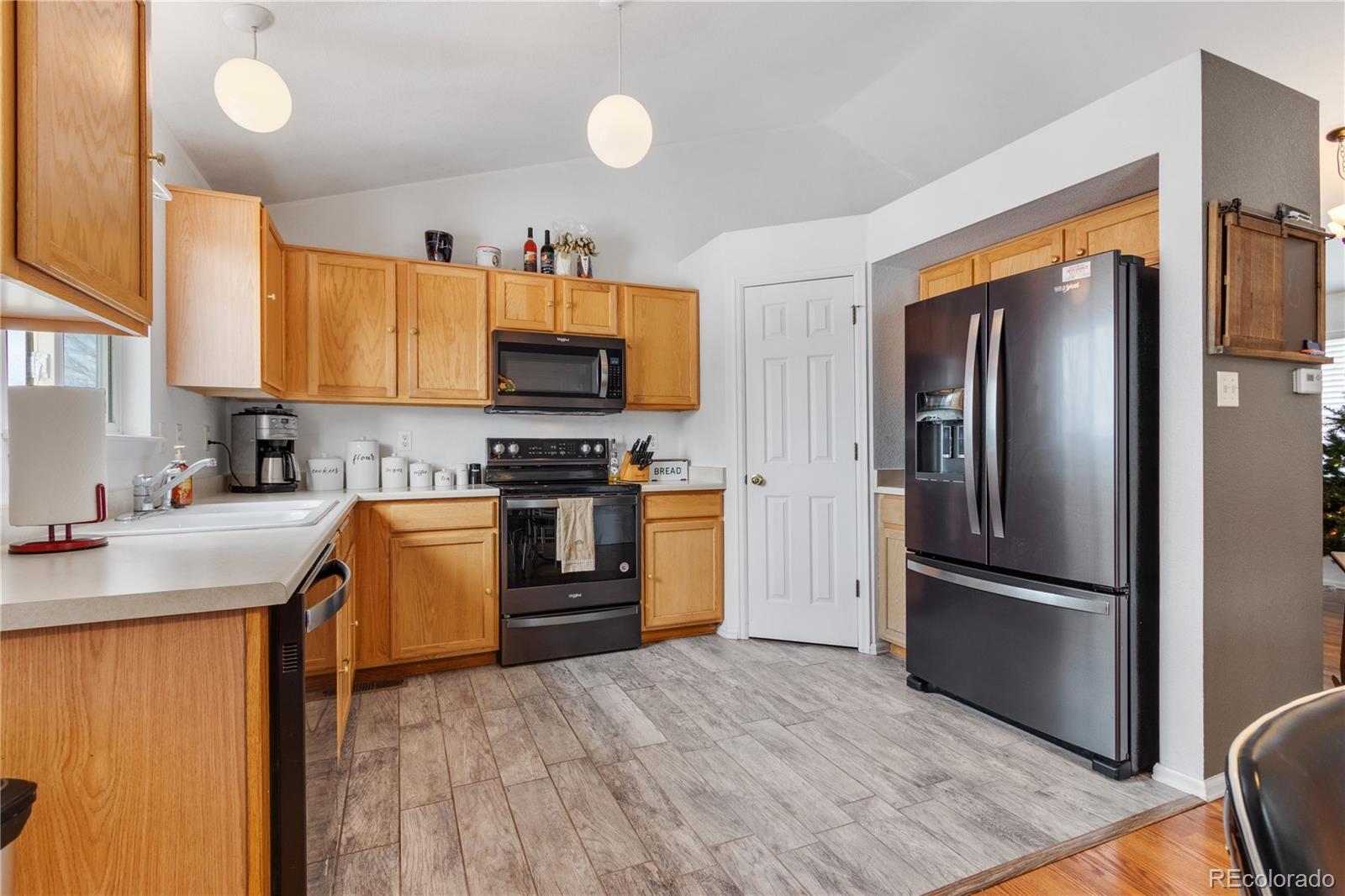 5405 Wolf Street Frederick, CO 80504 - Photo 12 of 36 a kitchen with stainless steel appliances granite countertop a refrigerator stove and sink