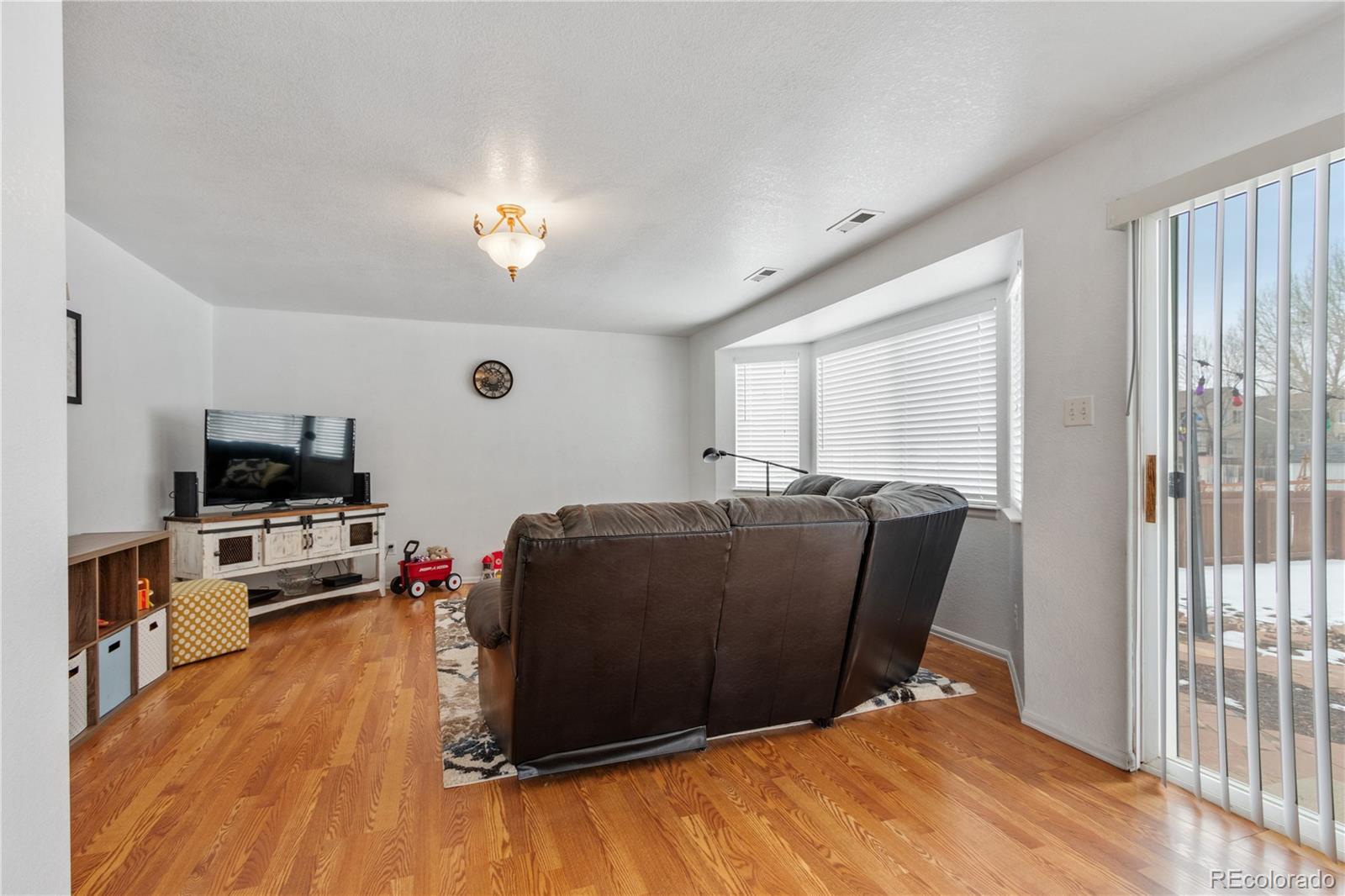 5405 Wolf Street Frederick, CO 80504 - Photo 13 of 36 a living room with furniture and a flat screen tv