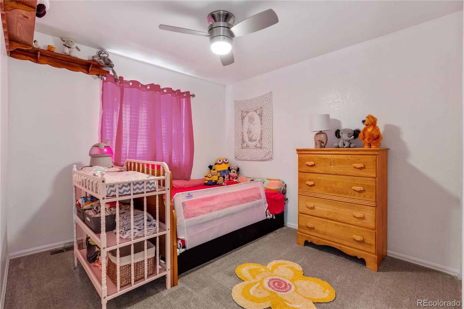 5405 Wolf Street Frederick, CO 80504 - Photo 21 of 36 a bed room with a bed and a dresser