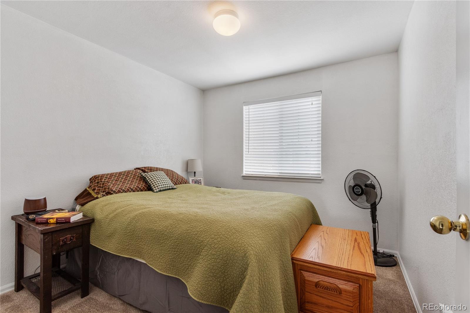 5405 Wolf Street Frederick, CO 80504 - Photo 23 of 36 a bedroom with a bed and a window
