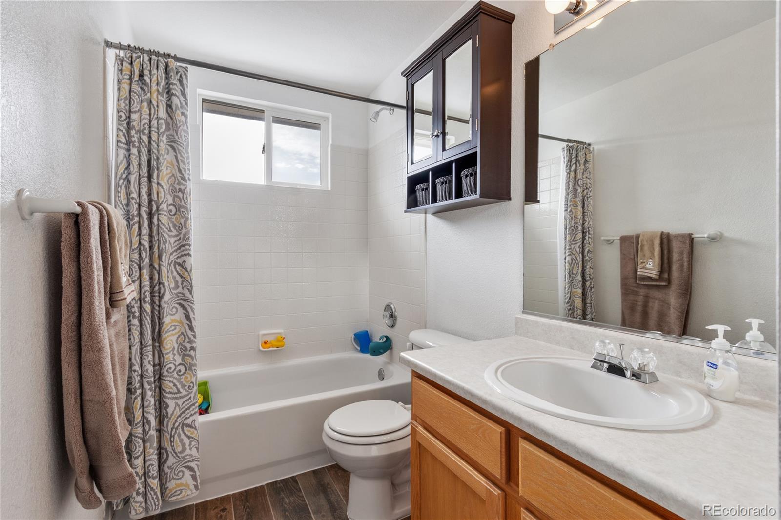 5405 Wolf Street Frederick, CO 80504 - Photo 25 of 36 a bathroom with a sink toilet and shower