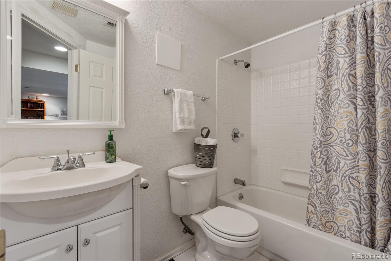 5405 Wolf Street Frederick, CO 80504 - Photo 27 of 36 a bathroom with a sink toilet vanity and shower