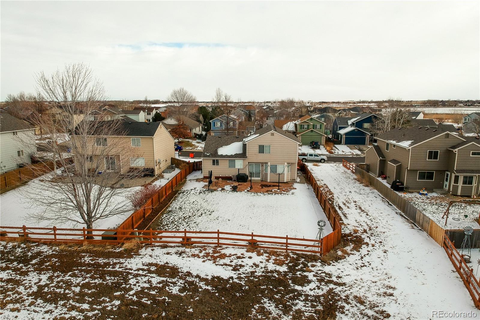 5405 Wolf Street Frederick, CO 80504 - Photo 34 of 36 an aerial view of a house with a yard and lake view