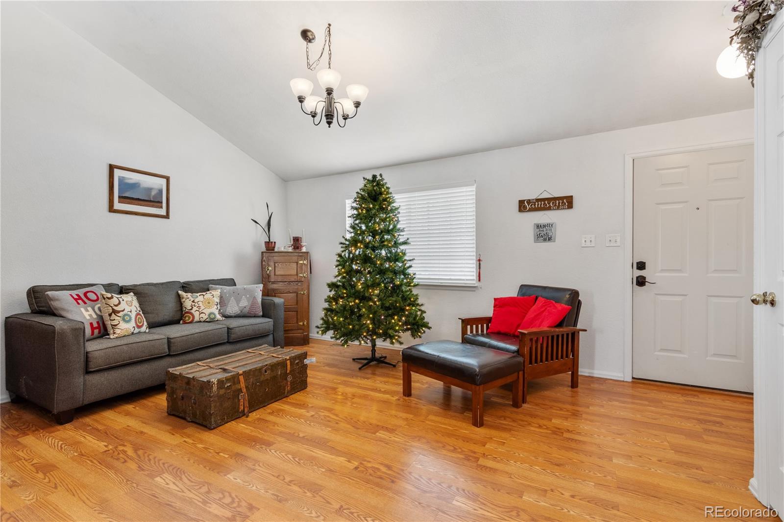 5405 Wolf Street Frederick, CO 80504 - Photo 7 of 36 a living room with furniture and a christmas tree